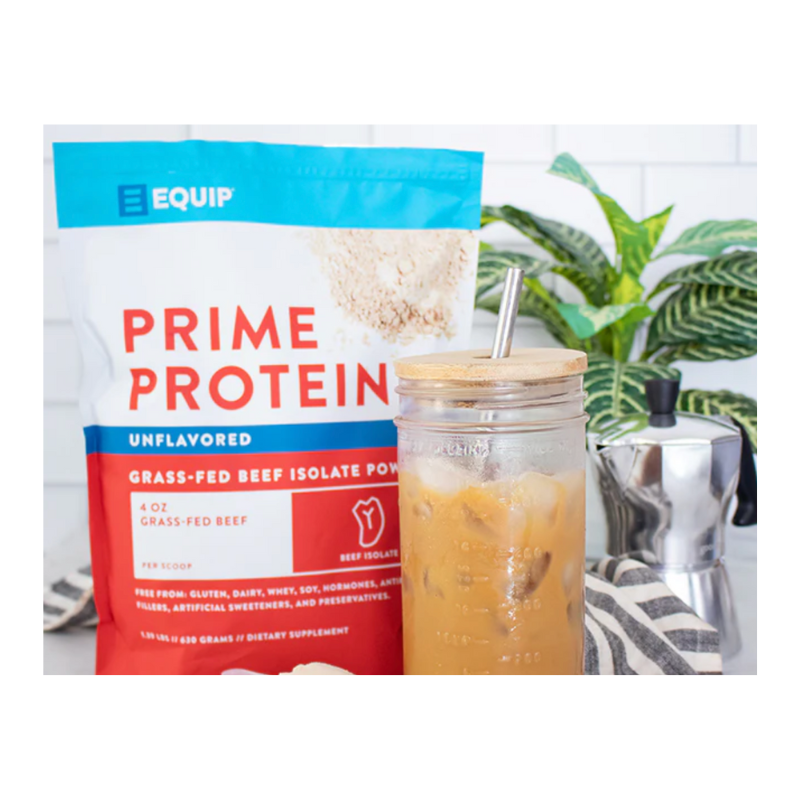 Package of Prime Protein powder with a glass of iced coffee on a white background
