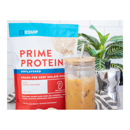 Package of Prime Protein powder with a glass of iced coffee on a white background