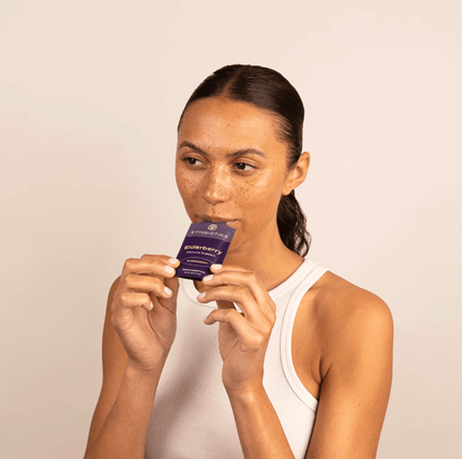 Image of woman eating Cymbiotika Elderberry Packets